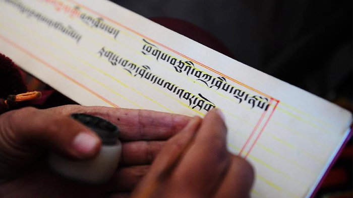 Dramatic Himalayan mountain peaks rising above the clouds in golden light