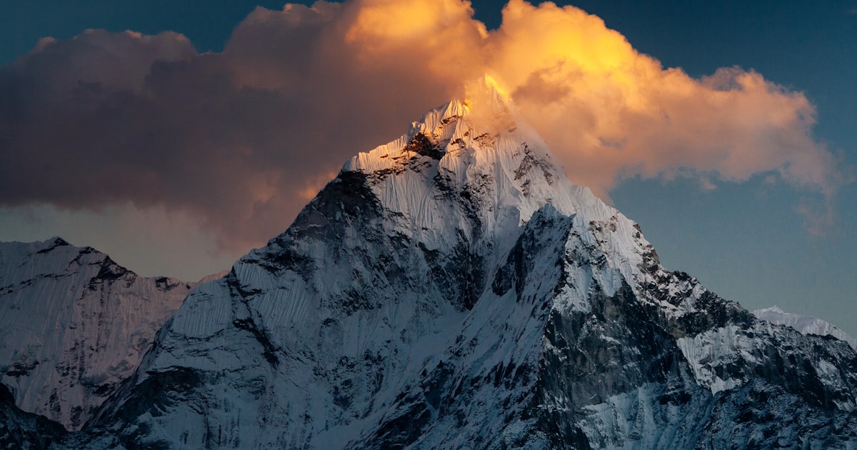 Colorful Tibetan prayer flags strung across a mountain valley
